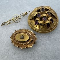 A collection of three antique brooches in precious yellow metal. Featuring a Victorian Etruscan