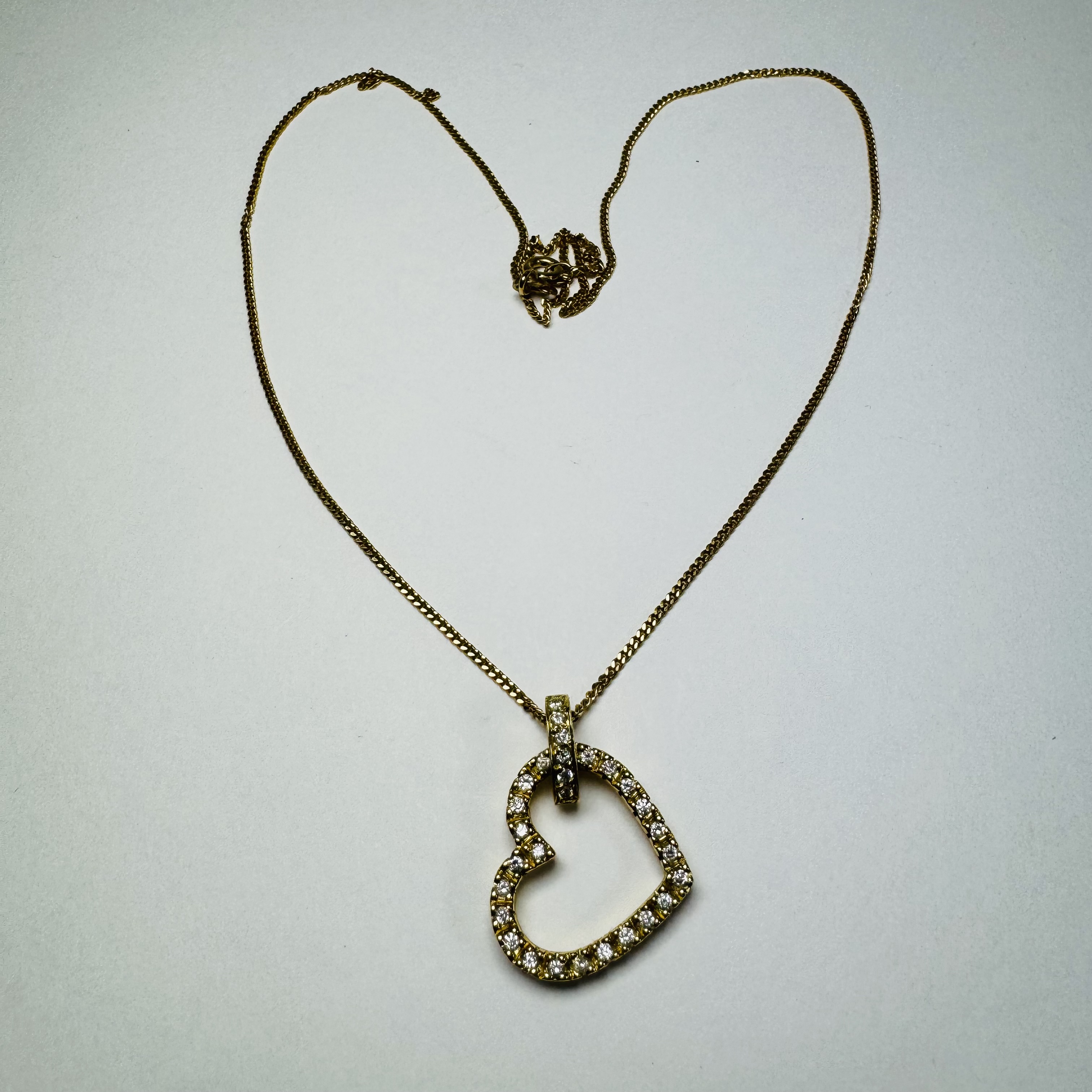 An 18ct gold diamond heart pendant on an 18ct gold chain. Set with 31 1.3mm round brilliant cut - Image 2 of 4