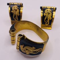 A 1930s Volex seahorse bangle and matching dress clips, after Jean Painleve. Made of bakelite and