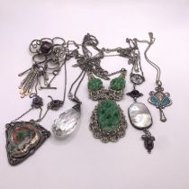 A collection of four art nouveau and arts and crafts necklaces, along with two other costume