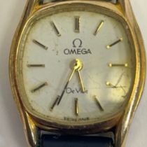 A ladies Omega De Ville quartz wristwatch with box and papers. White dial with baton markers in a