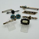 A collection of eight antique and vintage brooches. Featuring a Georgian mourning brooch, set with