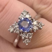 A bespoke handmade sapphire and diamond ring.  Featuring a central round mixed cut sapphire in a