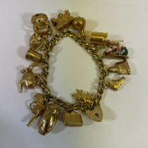 9ct Yellow Gold Charm Bracelet with 15 charms. Weight approximately 43.6 grams.