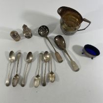 A collection of items to include: seven silver spoons, two pepper shakers, a Birmingham mustard