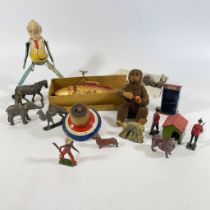 A template clockwork fish, a man doing the splits and other toys including lead figures.