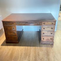 A good quality early 20th Century mahogany trim pedestal nine drawer directors desk by Maple & co.