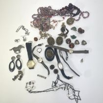 A collection of antique and vintage costume jewellery to include beads, watches, an hair work