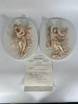 A pair of Parian ware plaques dating from 1870.  One featuring a female in peach and gilded