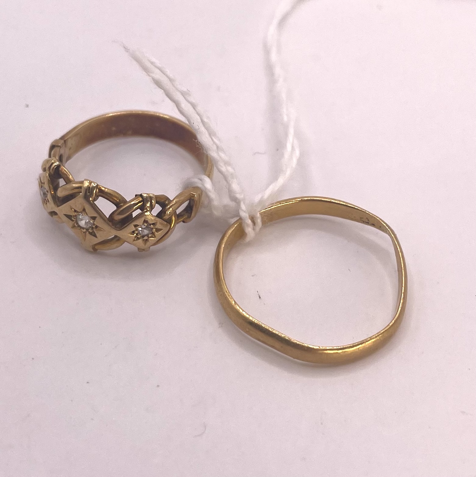 An 18ct yellow gold three stone diamond ring. Size O. Approximately 4.5 grams. Reasonably good,