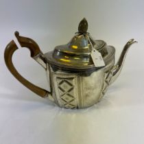 A George III teapot with bright cut engraving, embossed panels and pineapple knop finial. Marked to