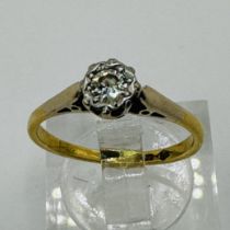 An illusion set 0.10 carat diamond solitaire ring in yellow precious metal. Marked "HS 18ct" to