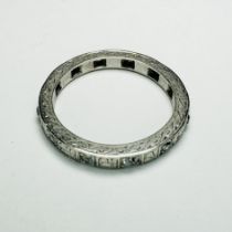 A diamond full eternity ring. In grey white precious metal which tests as platinum. Set with 12