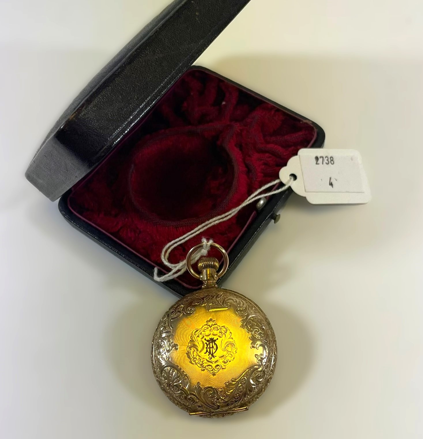 A "14K stamped American made engraved pocket watch  With a white enamel with Roman numerals and
