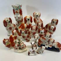 A collection of 18 various Staffordshire spaniel dogs. Chips and cracks throughout. Largest