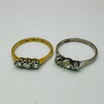 Two early 20th century diamond three stone rings. One a three stone diamond "18ct" stamped white