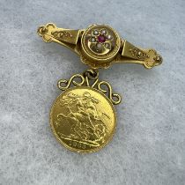 An Edward VII 1903 gold Sovereign suspended from a 9ct gold red stone and seed pearl set Etruscan