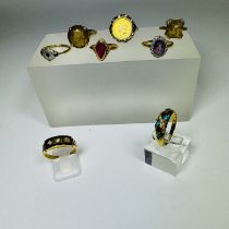 A collection of eight gold dress rings. Including a unmarked precious yellow metal amethyst and