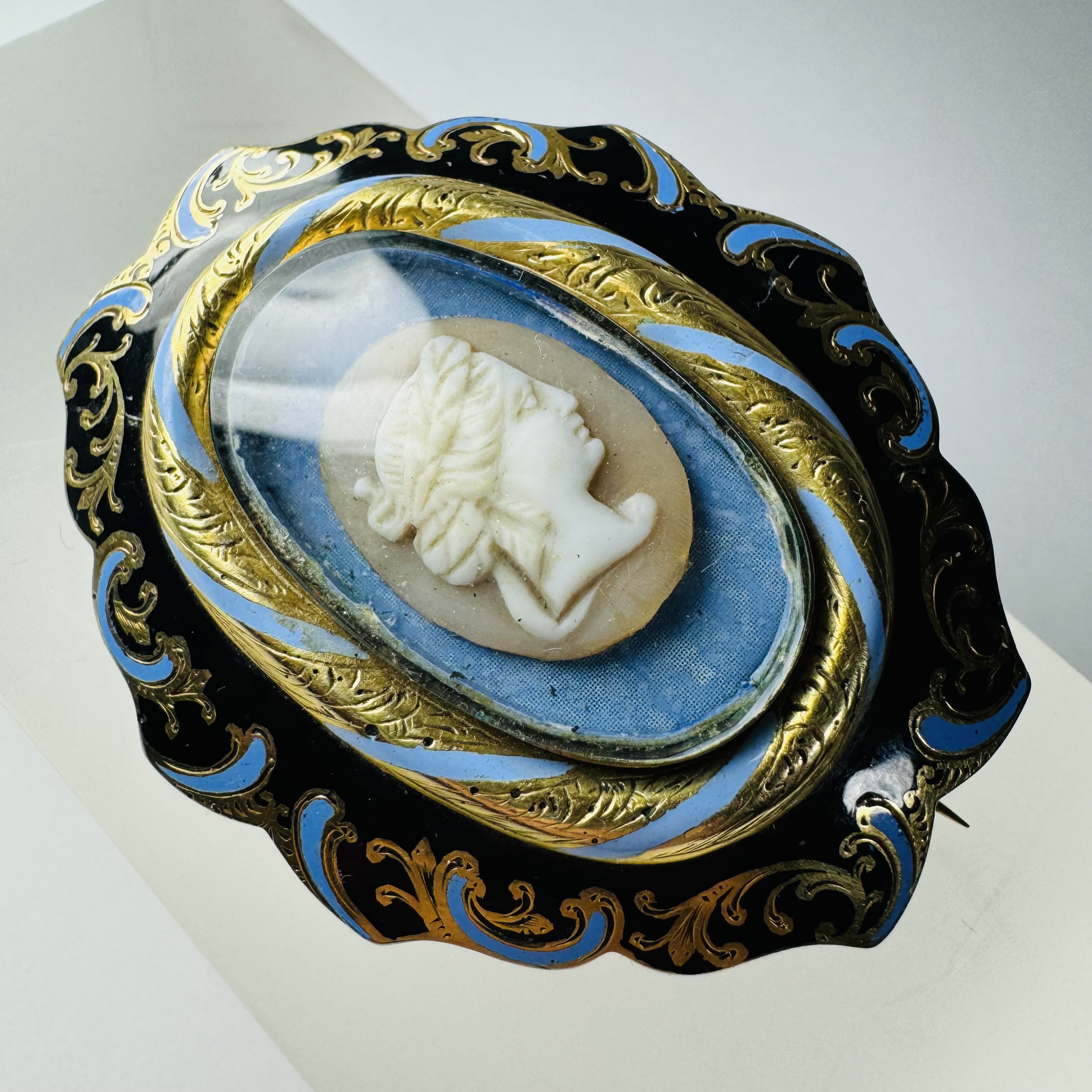 A Victorian enamelled mourning brooch in blue and black enamel. Engraved "In memory William