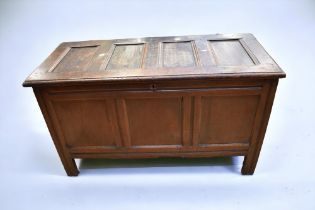 An early 18th Century English oak plain panelled coffer on block legs.