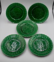 A small collection of majolica green ceramics consisting of cake stand, two smaller stands and