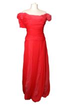 A red long evening dress with slit to the back, padded shoulders, diamante brooch, 100% silk, by