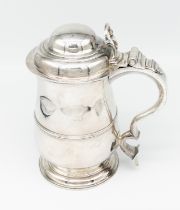 A George III silver quart tankard of baluster form with domed lid and scroll handle. Hallmarked 1765