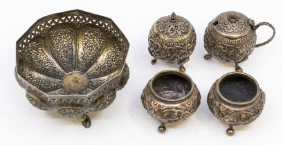 An Indo-Persian white metal Kutch bon bon dish, a pair of similar salts, pepperette & mustard pot.