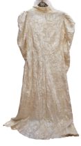 A crushed velvet wedding dress in cream from around 1939-1946, the dress has a small collar and