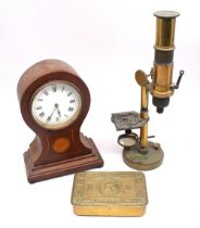 An Edwardian mahogany balloon mantle clock with flower inlay and Roman numerals along with a WWI