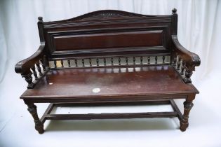 A mid 19th Century mahogany hall/waiting room bench, panelled back with spindle supports and