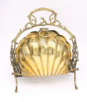 An early 20th century brass clam shell shaped food/bread warmer, with stylised pierced sides, floral