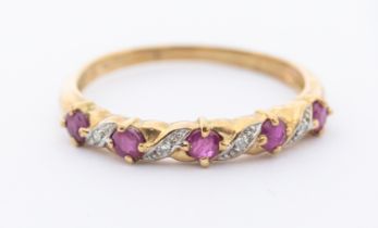 A ruby and diamond 9ct gold half eternity ring, claw set round mixed cut rubies with diamond