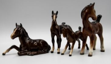 A collection of Beswick horses, all brown, various sizes, four foals. Tallest approx. 21cm high. One