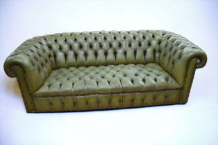 A mid 20th Century three seater Chesterfield suite, bottle green button back, no foot pads.