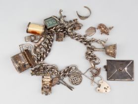 A silver charm bracelet, with various charms to include dog, car, lawn mower, skiier, £10 note,