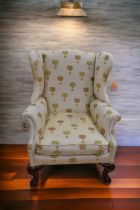 A mid 20th Century wingback armchair on casters along with a Victorian parlour chair