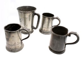 A small collection of 19th or 20th century pewter tankards, to include; a large MOD WWI large half