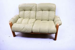 Three matching teak late 20th Century sofa chairs with light green leatherette covers, 2 x 3