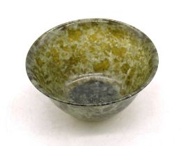 A small turned Chinese spinach jade bowl, diameter 10cm, height 5cm. No damage.