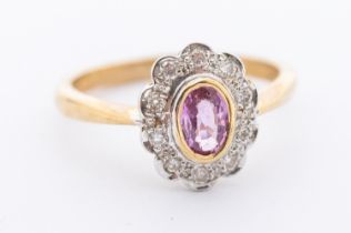 A pink sapphire and diamond 9ct gold oval cluster ring, comprising an oval mixed cut sapphire approx