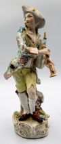 An early 20th Century Meissen figure of a bagpipe player, marks and number to base, chips to bagpipe