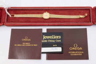 Omega- a ladies vintage 9ct gold wristwatch comprising a signed gilt cushion shaped dial with