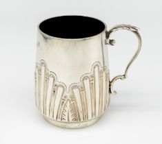 A Victorian silver christening mug, having embossed and chased design to side, circular footed base,