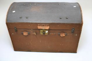 An early 20th Century dome topped travel trunk, with travel labels/stickers to sides.