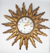An antique French giltwood sunburst wall clock with enamel dial Lepauter, Paris. Diameter 50cm