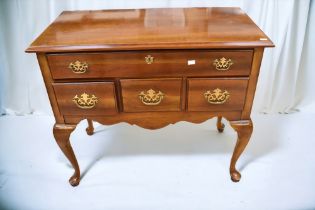 A reproduction mahogany lowboy with top single drawer and three drawers below on cabriole legs along