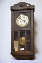 A 1930s oak 8 day clock with Arabic numerals.