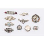Ten mixed antique & vintage silver brooches including Scottish hardstone, topaz and garnet.