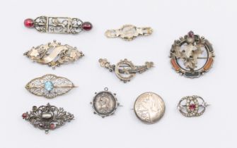 Ten mixed antique & vintage silver brooches including Scottish hardstone, topaz and garnet.